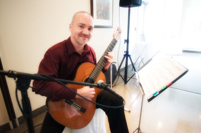 Dave Milliken playing classical guitar at the wedding of Juliane Boushey